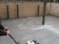 Commercial concrete floor for dumpster enclosure.