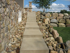 Concrete driveway, stairway and upper level concrete patio completed by Akerly  Concrete Construction.