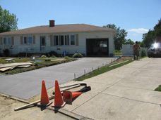 New construction concrete driveway next to old residential driveway replacement.